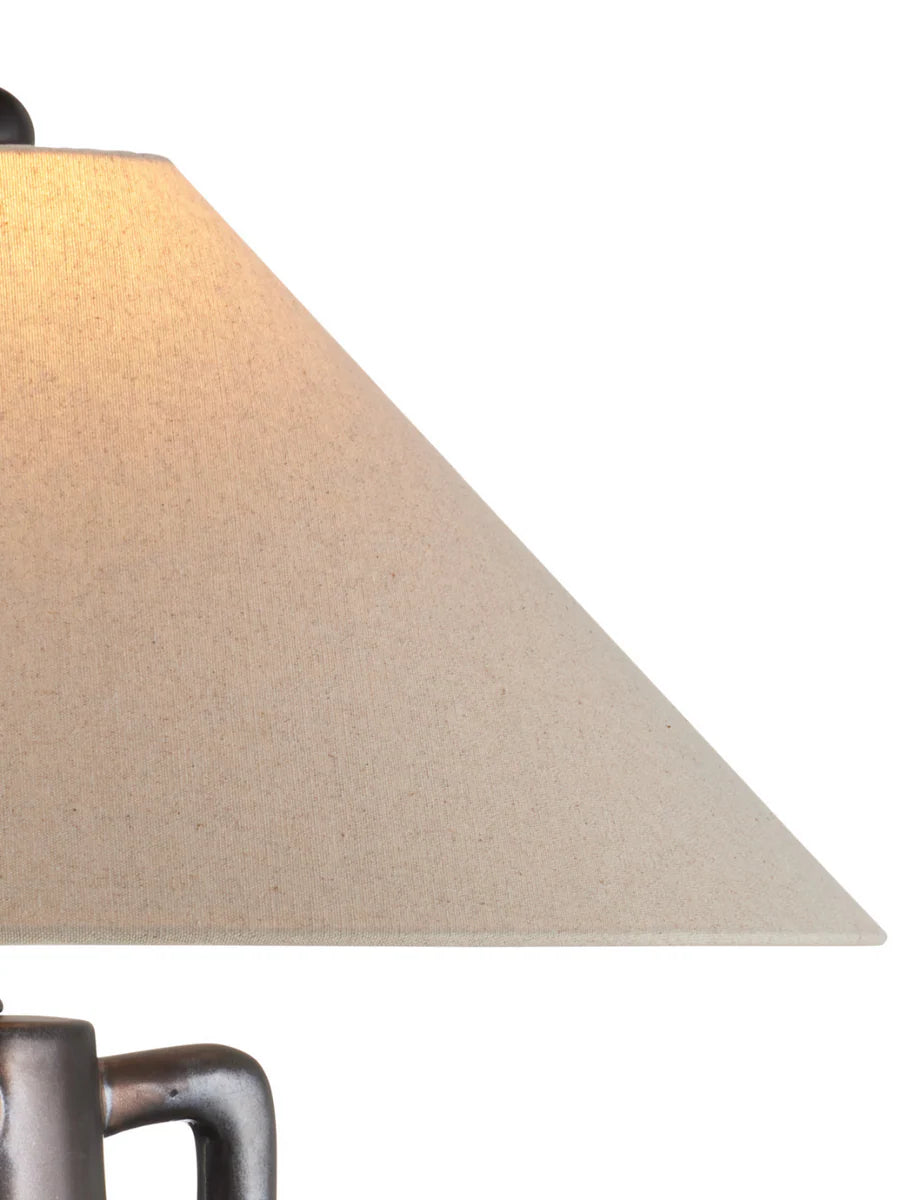 Jug-shaped gray ceramic table lamp with reactive glaze finish, bronze accents, and a classic empire shade.