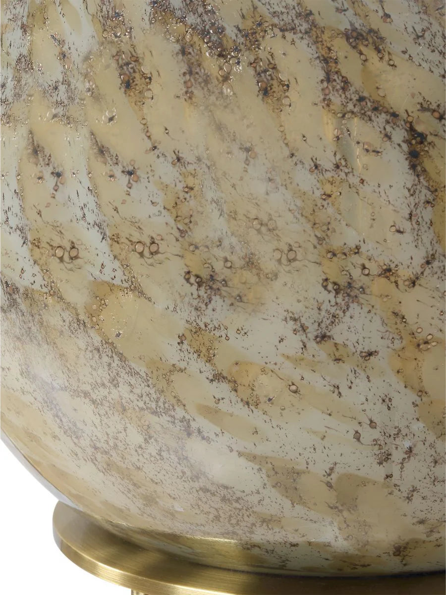 Sahara Breeze table lamp with brown seeded glass base, antique brass accents, and white linen shade.
